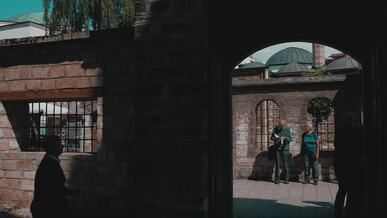 historic courtyard scene with visitors and shadows