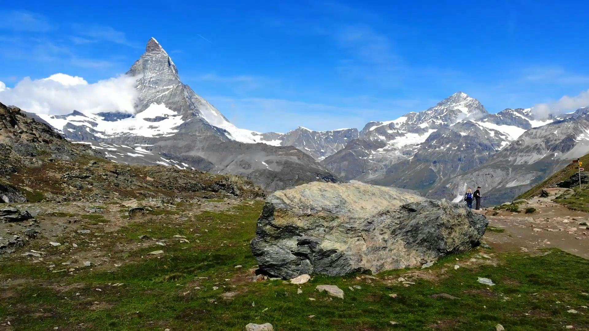 Mountain Ranges With Snow Under A Blue Sky · Free Stock Video