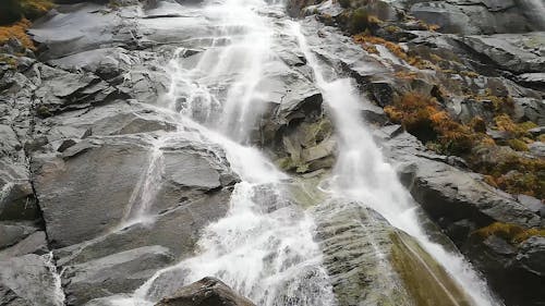 Waterfalls Cascading Down The Cliff Rocks Of A Mountain Side