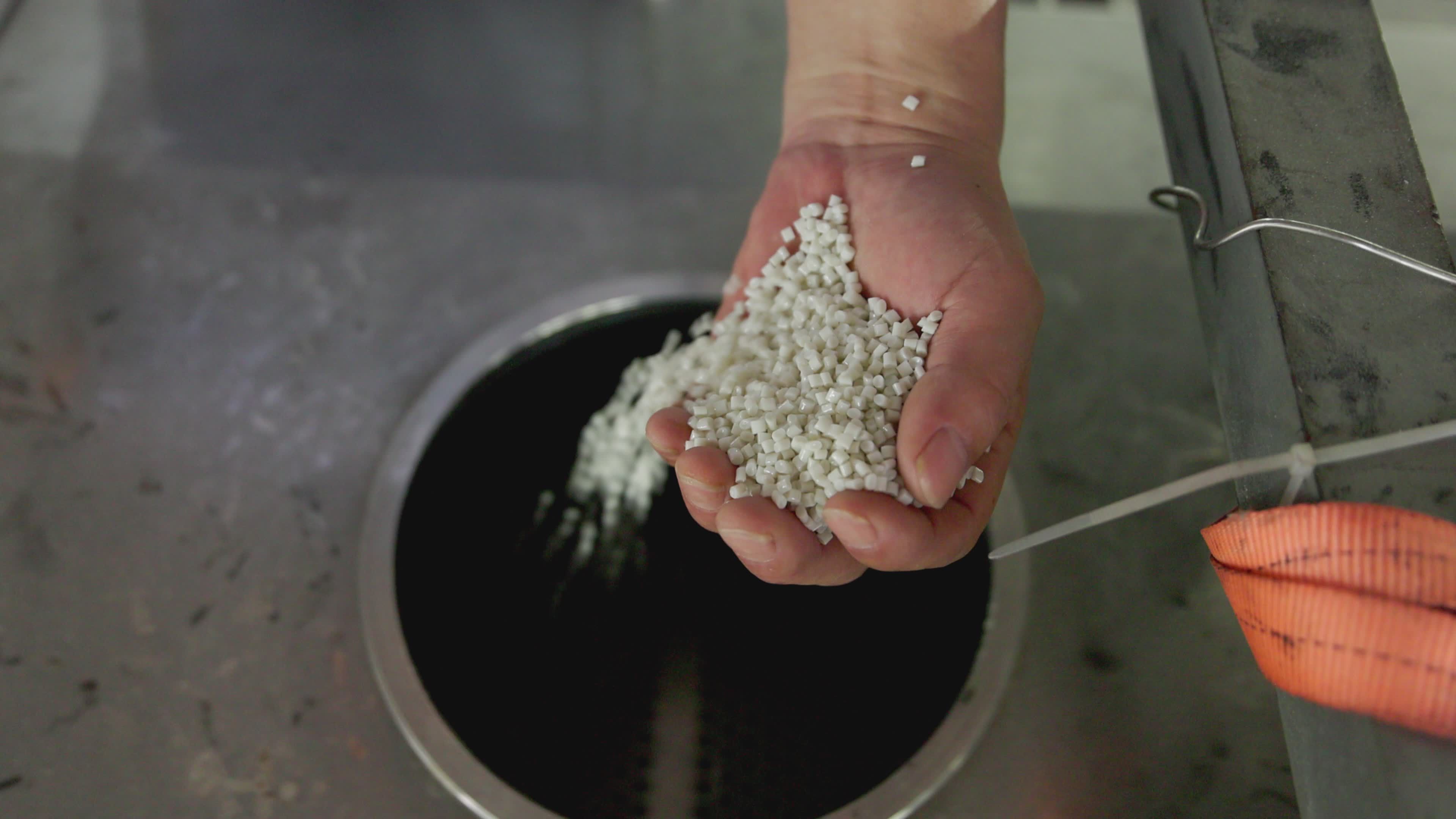 Hand Pouring Polymer Pellets into Industrial Container Free Stock Video ...