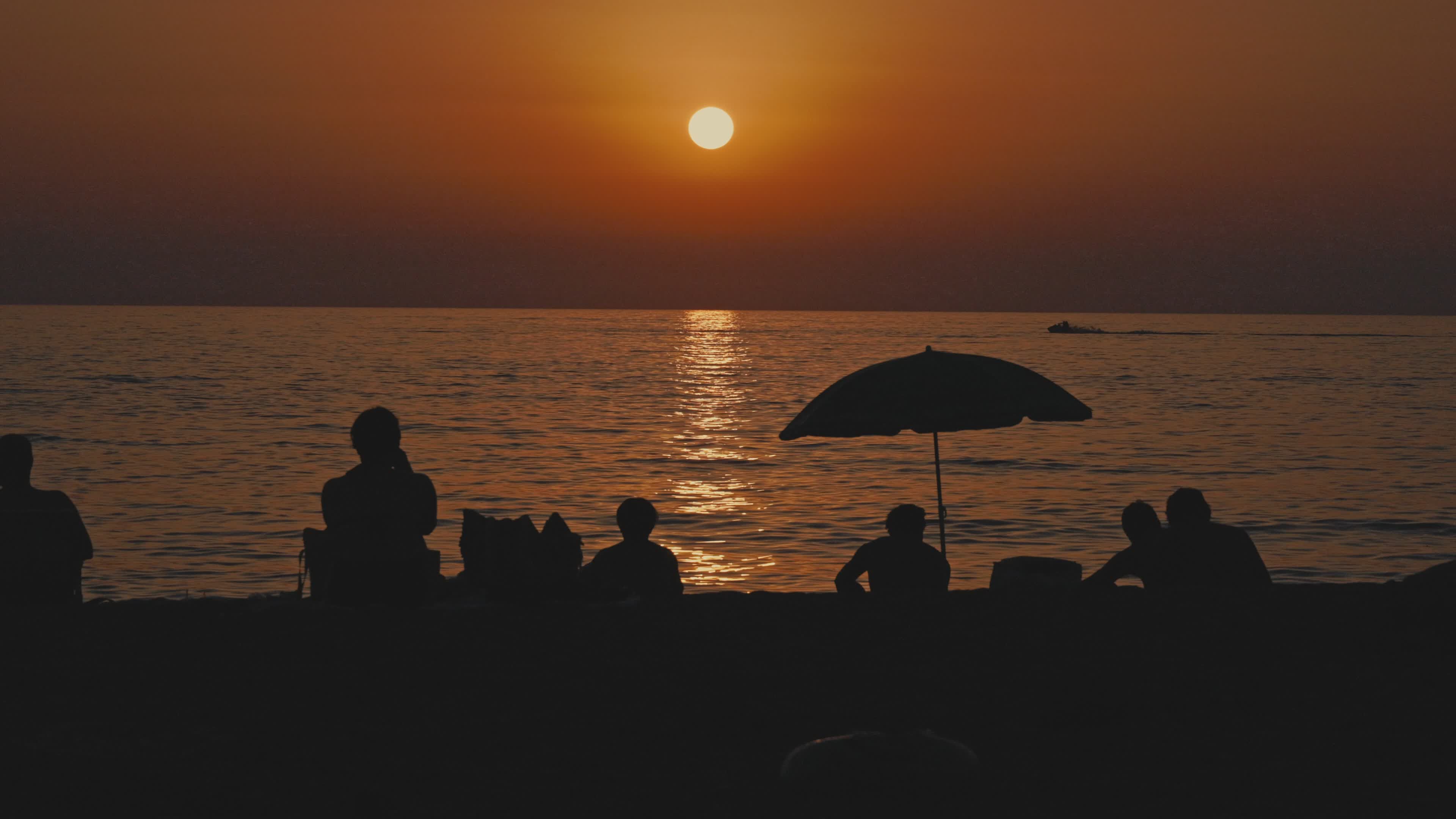 Silhouetted Group Relaxing at Sunset Beach Free Stock Video Footage ...