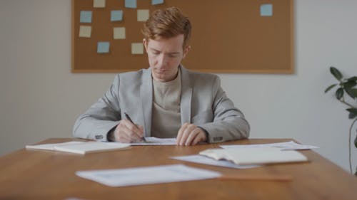 Young Man Writing In The Office