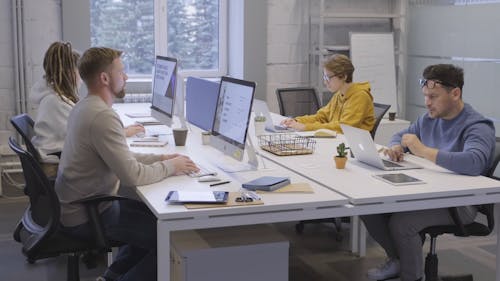 A Group Of People Busy Working With Their Computers