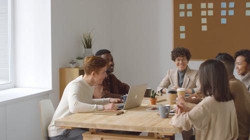  Group Of People Standing And Shaking Hands At The End Of A Business Meeting