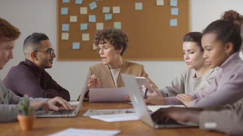 A Group Of People Discussing In A Business Meeting