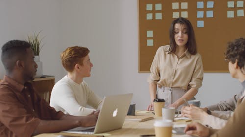 A Woman Introducing Herself To Group In A Meeting By Offering A Handshake 