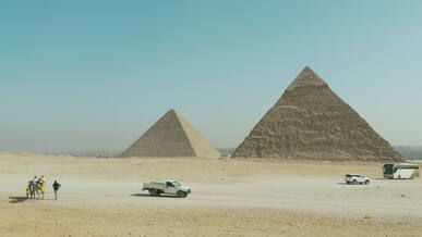 pyramids of giza with tourists and camels