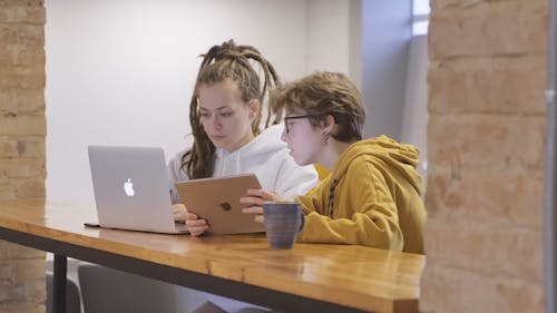 People Using Laptop And Tablet