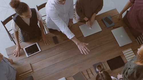 A Group Of People Put Their Hands Together Gesturing Alliance