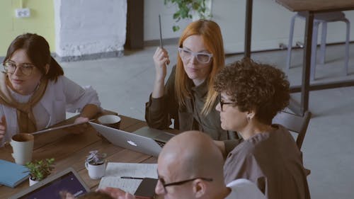 A Group Of People In Discussion At A Business Meeting