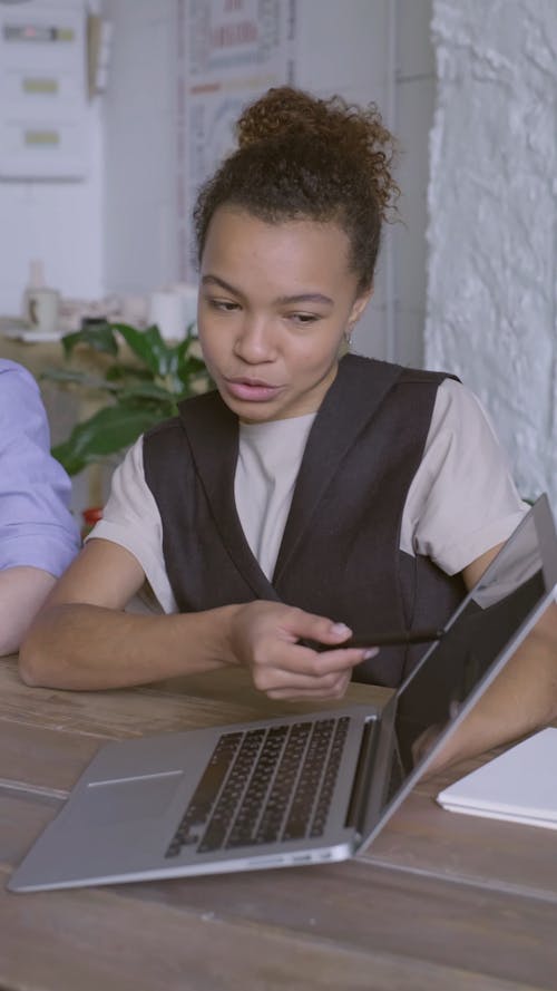 A Woman Discussing Something On A Laptop