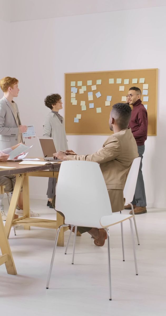 a group of people having a discussion in a business meeting 3256768