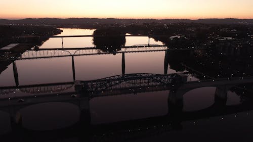 Aerial View Of Bridges On A River At Sunset