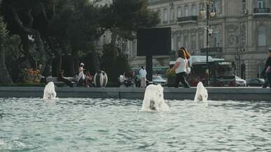 lively fountain and people in urban park