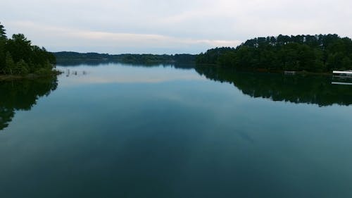 Drone Flying Over A Lake With A Smooth Surface