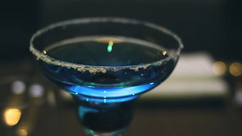 A Color Blue Alcoholic Drink On A Crystal Cocktail Glass