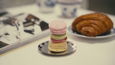 colorful macarons and croissant on stylish plate