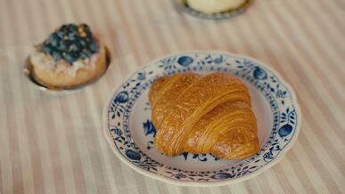 delicious croissant on elegant blue floral plate