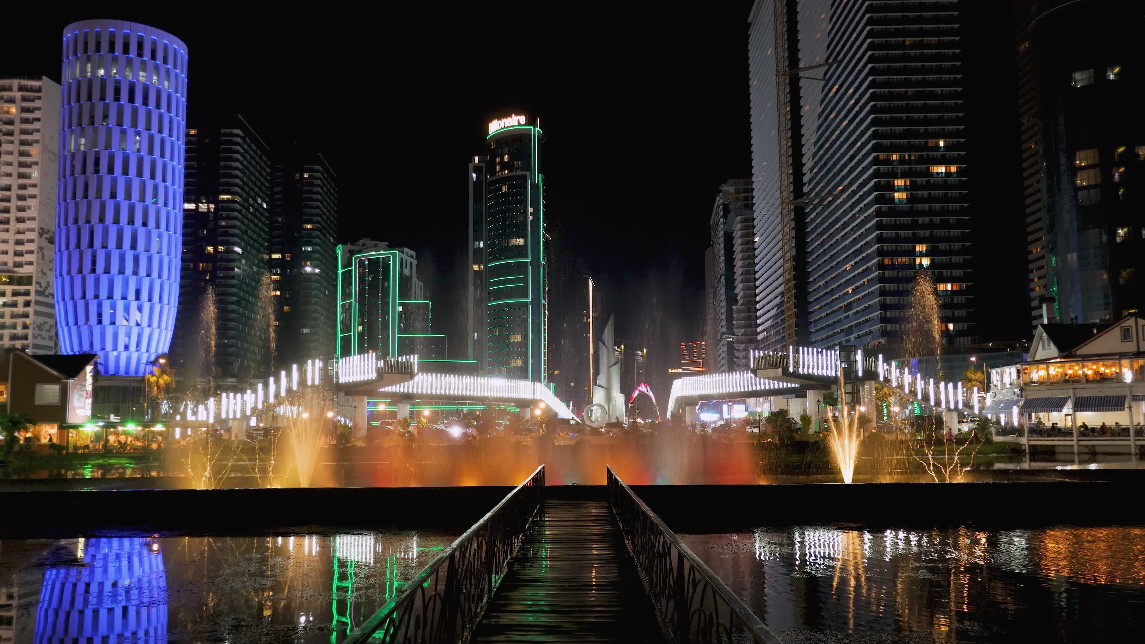 Vibrant City Skyline with Illuminated Fountains at Night Free Stock ...