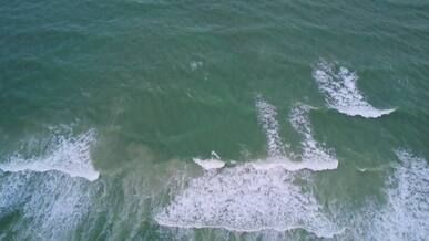 aerial view of ocean waves crashing