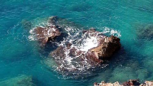 A Rock Formation Submerged On A Seashore 