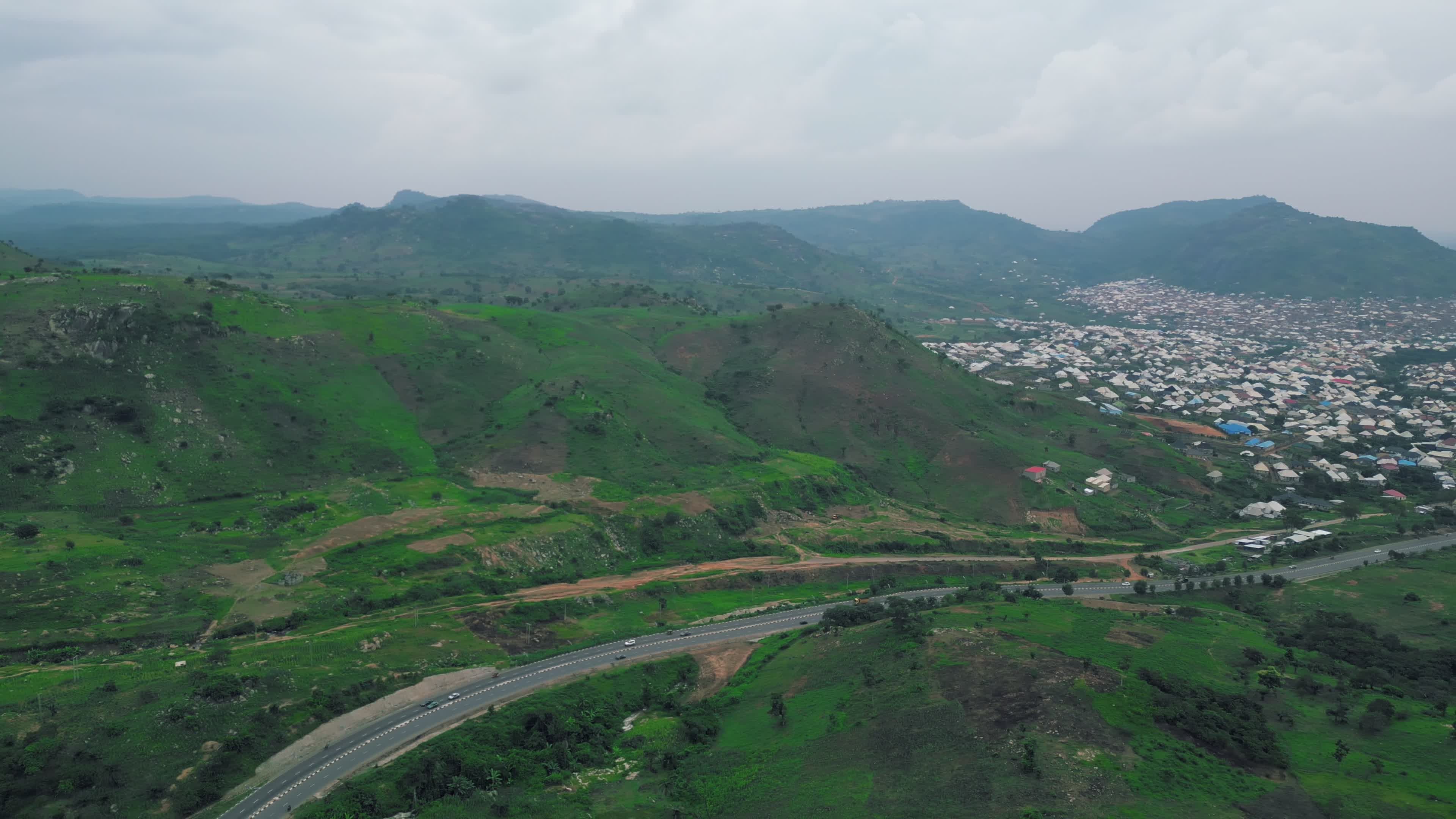 Aerial View of Lush Green Hills and Cityscape Free Stock Video Footage ...