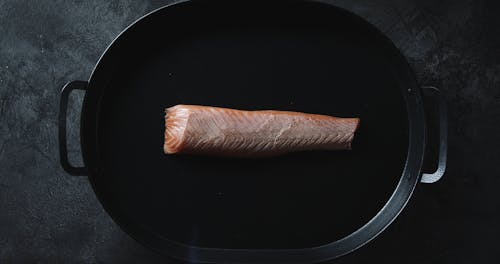 Using A Blow Torch To Cook The Outer Coat Of A Salmon Meat Slab 
