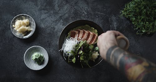 Drizzling A Dish Of Salmon With Liquid Sauces