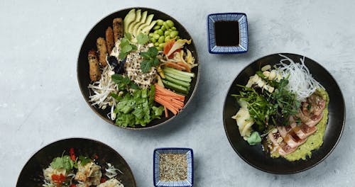 Picking An Ingredient From A Bowl Of Dishes Using A Chopstick