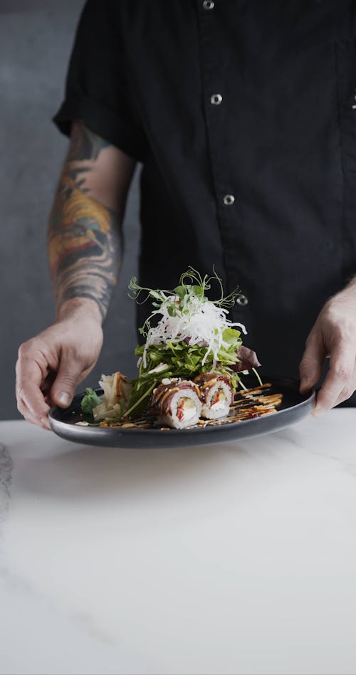 A Chef Prepares A Sushi Rice Roll Fusion With Vegetable Toppings