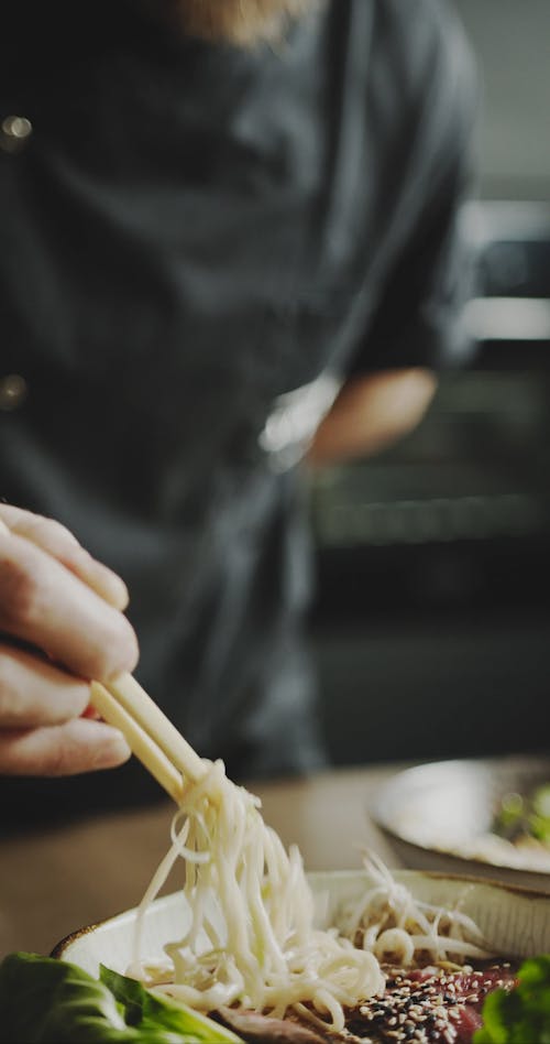 A Chef Checking The Noodles Of Bowl Dish