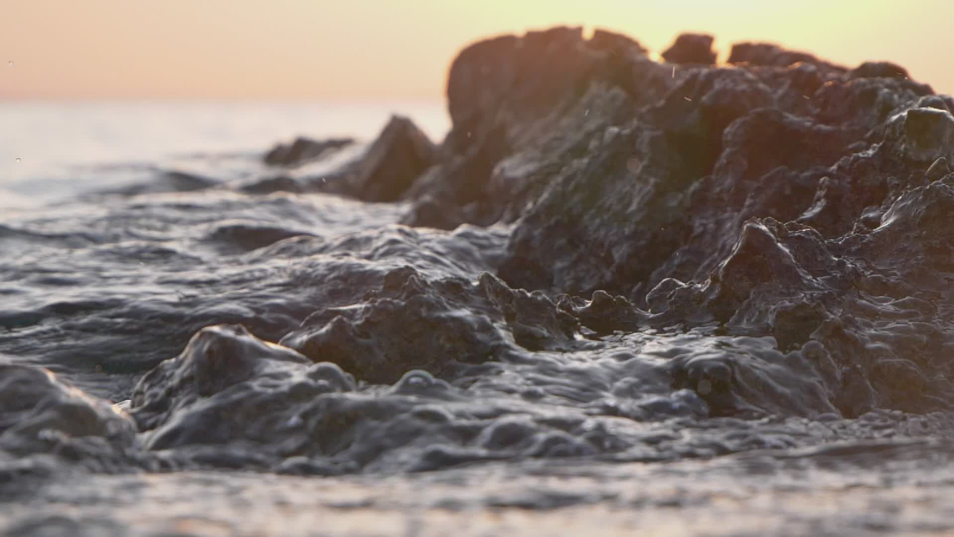 Peaceful Waves Crashing on Rocky Shoreline at Sunset Free Stock Video ...