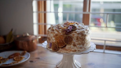 A Cake With Decorations Over A Cake Stand