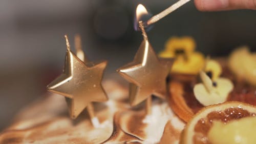 Lighting A Star Shaped Candles Using A Match Stick