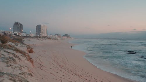 Man Walking on the Shore