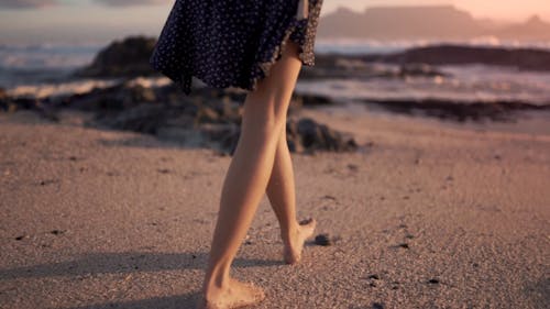 Woman Walking Barefooted On The Shore 