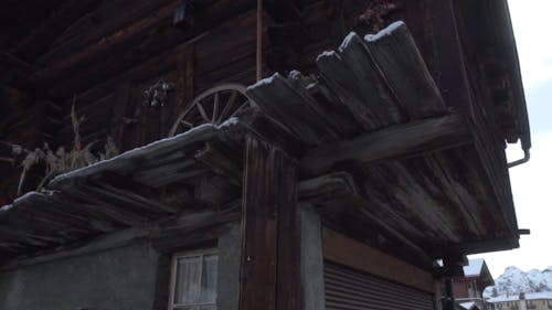 Exterior Of A Wooden House On A Mountain Covered With Snow