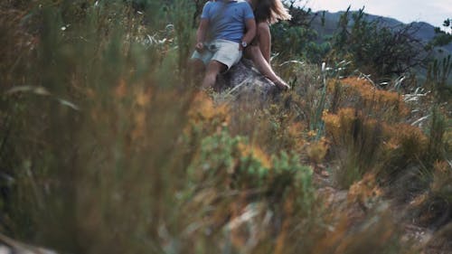 Couple Sitting on a Boulder