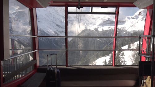 Riding Cable Cars To Reach The Mountain Ski Resort In Switzerland