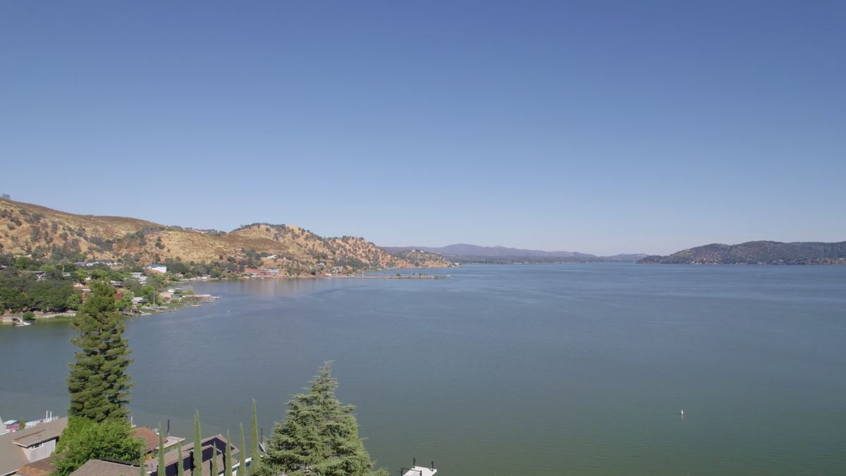 Peaceful Lakeside View with Mountain Backdrop Free Stock Video Footage ...