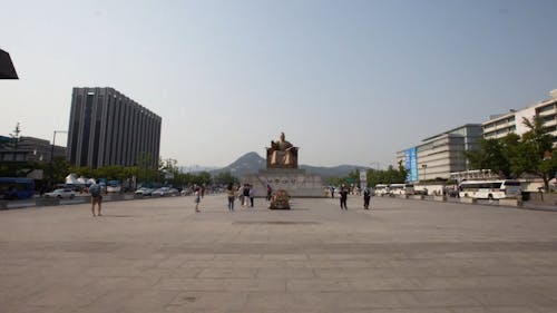 People Visiting A Monument Built In A Park 
