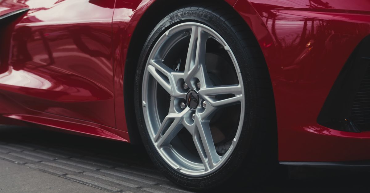 Close-Up of Sleek Red Sports Car Wheel on Pavement Free Stock Video ...