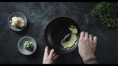 a chef plating a serving of salmon sahimi