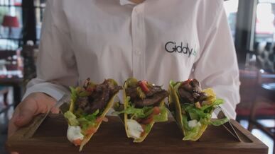 delicious tacos presented on wooden board