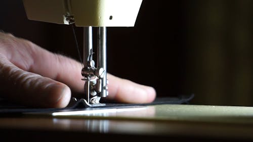 A Tailor Using A Sewing Machine