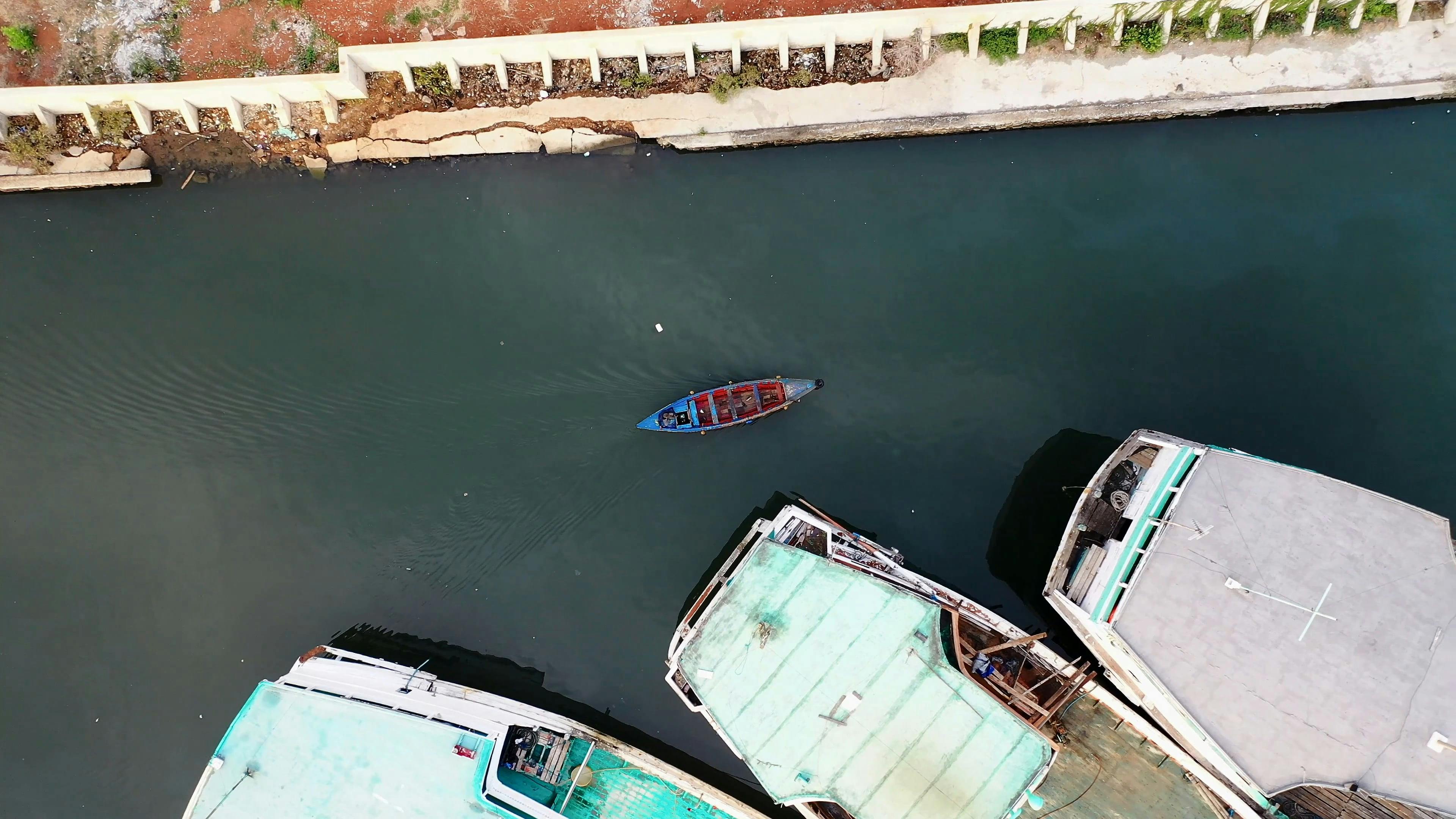 A Small Motor Boat Moving Past Large Fishing Boats In A Seaport Free Stock  Video Footage, Royalty-Free 4K & HD Video Clip