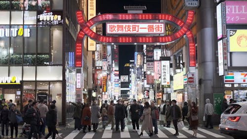 People Walking Around The City During Night