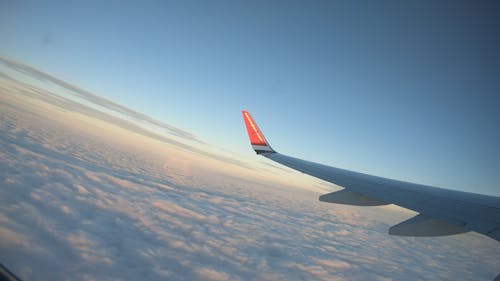 An Airplane Flying Above The Sea Of Clouds