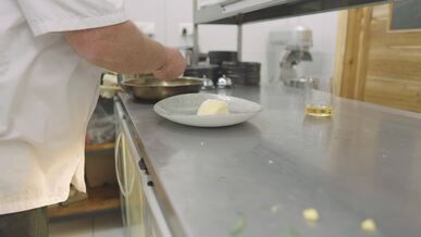 professional chef preparing gourmet dish in kitchen
