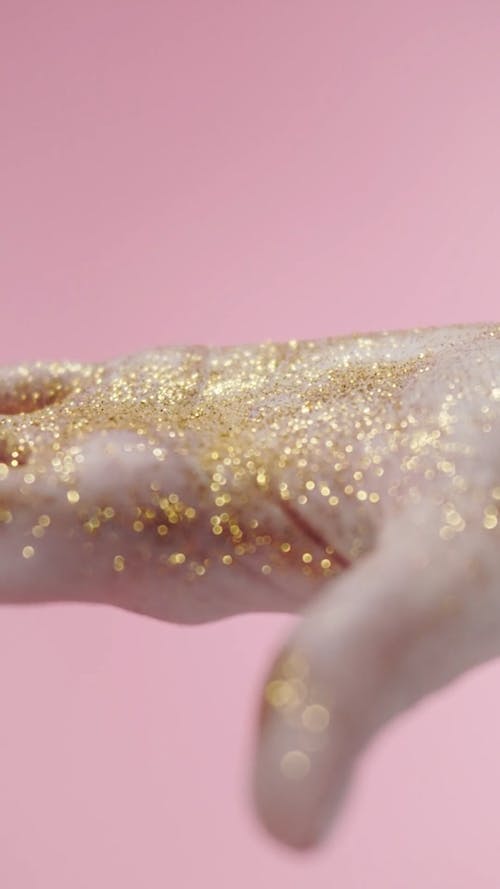 Palm Of A Hand Full Of Gold Glitters